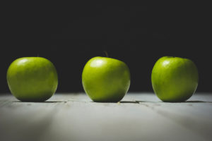 three bright green apples sitting on table - biological aspect of addiction recovery