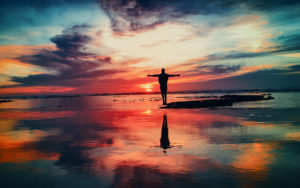 Iowa Addiction Treatment, Christ-Centered Addiction Treatment, brilliant sunset with person silhouetted on a sand bar at sea - Christ centered addiction treatment