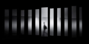 Addiction Treatment or Jail, view from behind bars - black and white - addiction treatment or jail