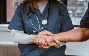 nurse holding patient's hand - medical help for withdrawal symptoms