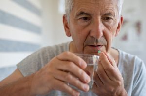 Seniors Using Opioids, senior citizen man taking pill