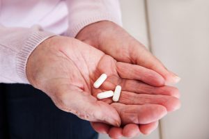 What to do if You or a Loved One is Addicted to Xanax, How to Help a Loved One With a Prescription Drug Problem, senior citizen hands holding pills