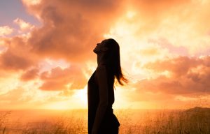 silhouette of woman looking skyward - sunset - spirituality