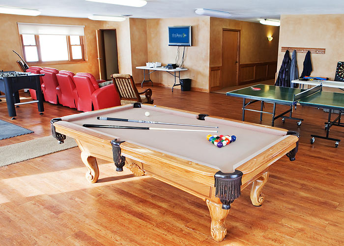 game room with pool table, table tennis, Foosball, and red recliners