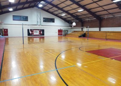inside of gym with basketball and volleyball court
