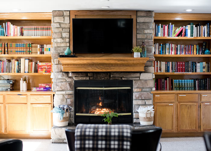 room with built-in bookshelves full of books and a fireplace - St. Gregory Recovery Center - Iowa addiction treatment center - faith-based rehab in Iowa