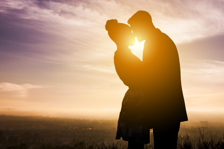 Diverse Couple Engagement Silhouettes at Sunset